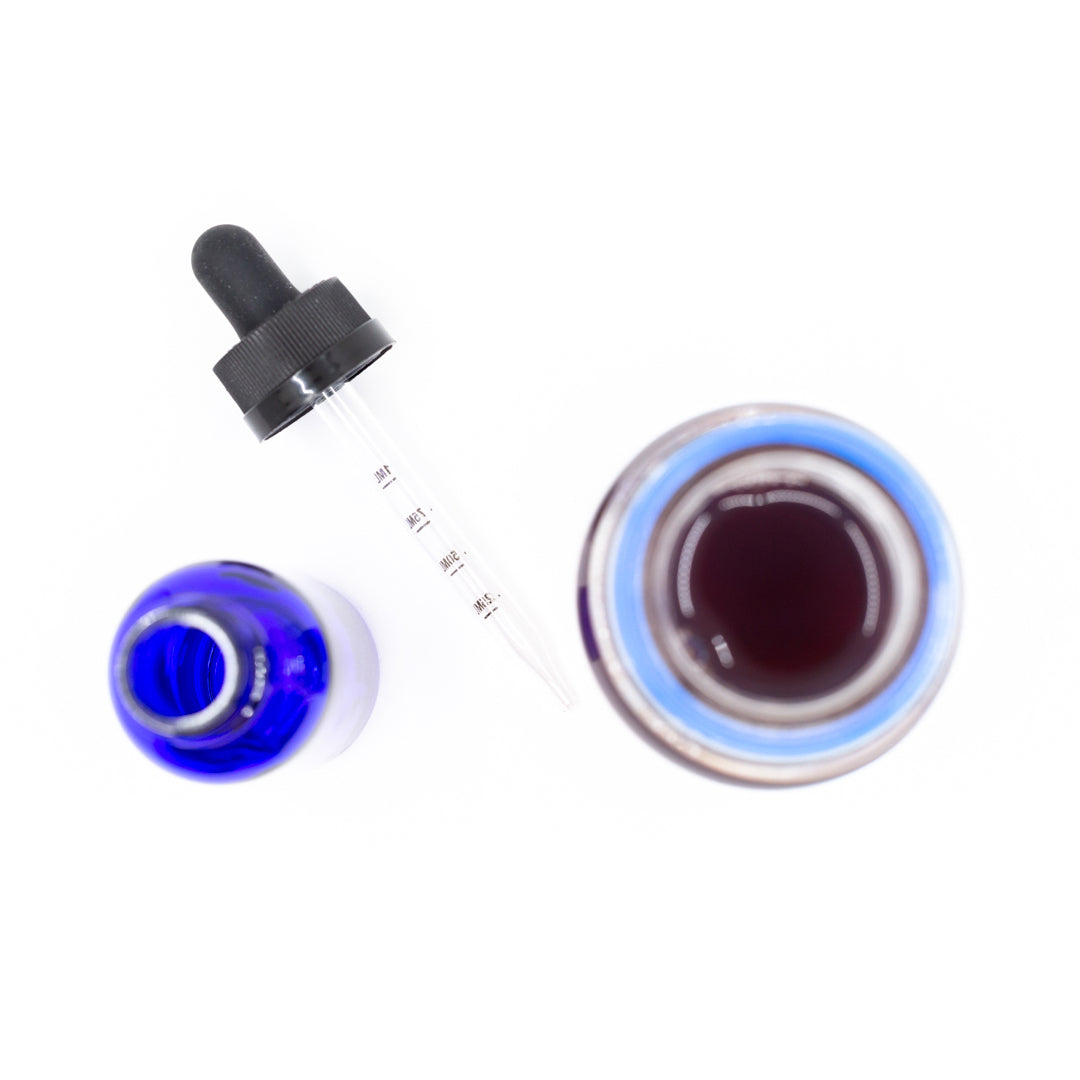 Birdseye view of two vials and a liquid dropper cap