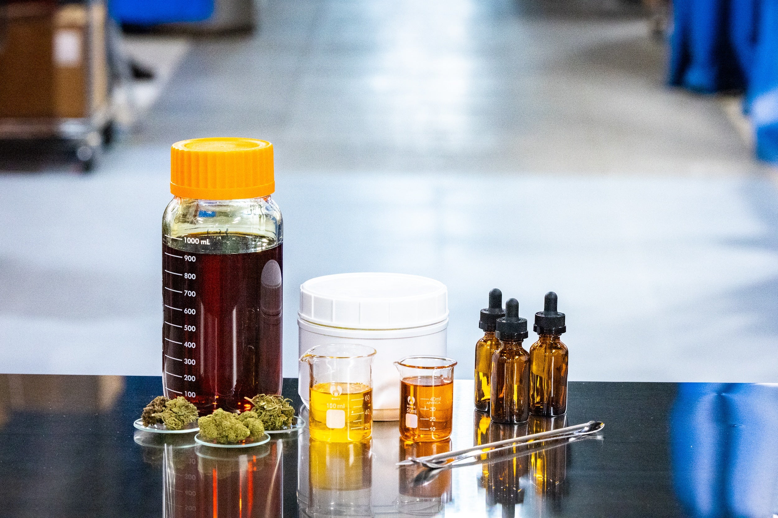 Oils, buds, and various items arranged on a table, with a focus on mixing fluids for preparation.